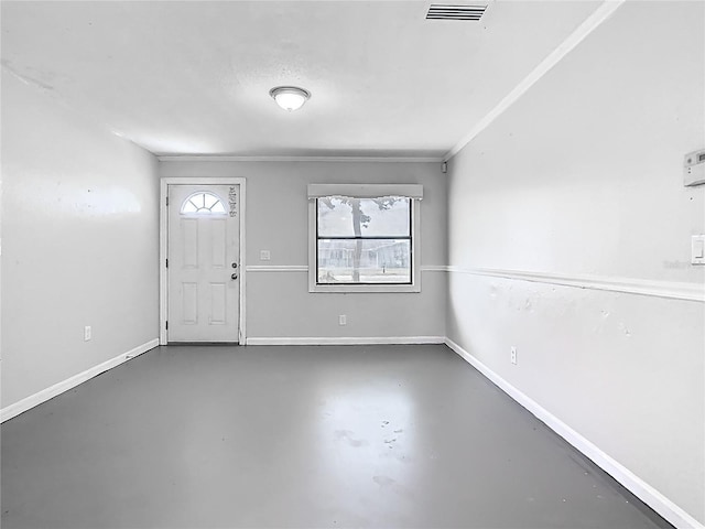foyer featuring baseboards, visible vents, and finished concrete flooring