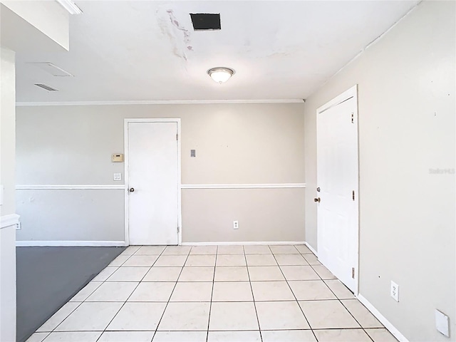 unfurnished room featuring visible vents, baseboards, and crown molding
