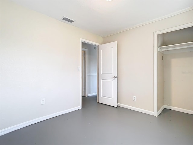 unfurnished bedroom featuring concrete floors, visible vents, and baseboards