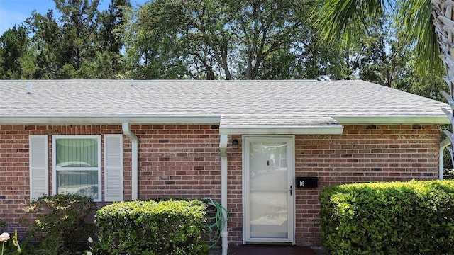 3 Fairway Ct, Deland, FL 32724 - doorway to property featuring brick siding and roof with shingles