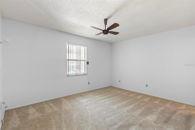 3 Fairway Ct, Deland, FL 32724 - empty room with baseboards, a textured ceiling, a ceiling fan, and light colored carpet