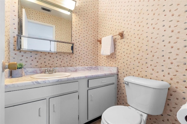 3 Fairway Ct, Deland, FL 32724 - bathroom featuring wallpapered walls, toilet, vanity, and visible vents