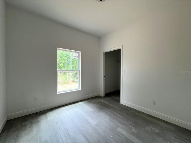 516 Model St, Daytona Beach, FL 32114 - empty room featuring baseboards and dark wood-type flooring