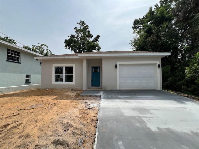 516 Model St, Daytona Beach, FL 32114 - view of front of home featuring concrete driveway, stucco siding, and a garage