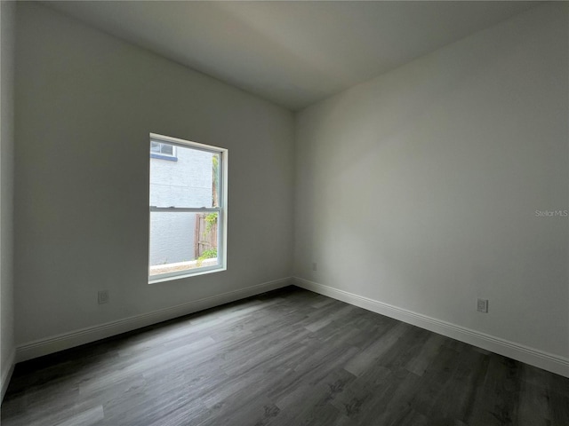 516 Model St, Daytona Beach, FL 32114 - spare room featuring dark wood-style floors and baseboards