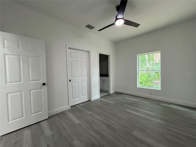 516 Model St, Daytona Beach, FL 32114 - unfurnished bedroom with dark wood-style floors and a ceiling fan