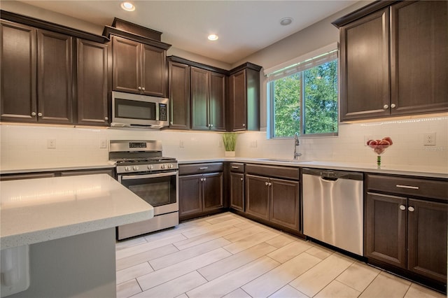 258 Rustic Loop, Sanford, FL 32771 - kitchen with recessed lighting, a sink, dark brown cabinetry, decorative backsplash, and appliances with stainless steel finishes