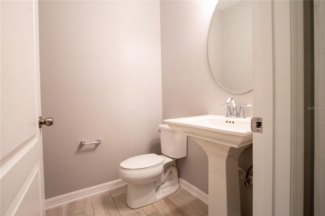 258 Rustic Loop, Sanford, FL 32771 - half bath featuring a sink, toilet, wood finished floors, and baseboards
