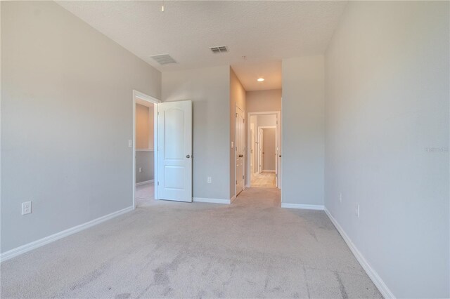 258 Rustic Loop, Sanford, FL 32771 - unfurnished bedroom with light carpet, baseboards, visible vents, and a textured ceiling