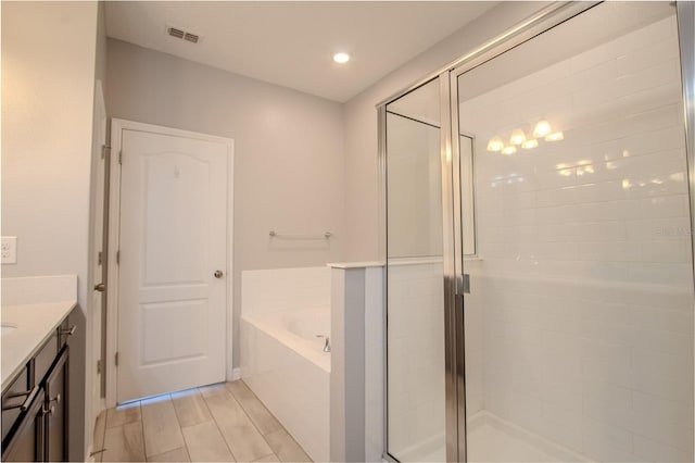 258 Rustic Loop, Sanford, FL 32771 - bathroom featuring a bath, vanity, a stall shower, and visible vents