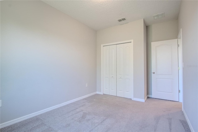 258 Rustic Loop, Sanford, FL 32771 - unfurnished bedroom with a textured ceiling, visible vents, carpet floors, and a closet