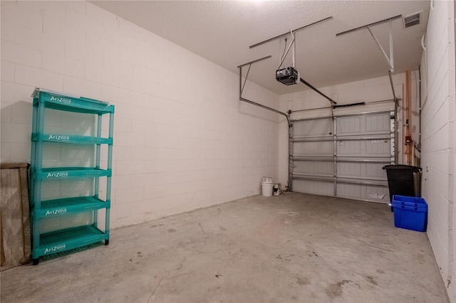 258 Rustic Loop, Sanford, FL 32771 - garage with concrete block wall, visible vents, and a garage door opener