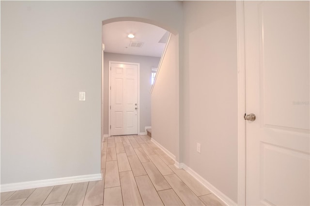 258 Rustic Loop, Sanford, FL 32771 - hallway with wood tiled floor, arched walkways, visible vents, and baseboards
