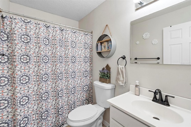 bathroom featuring toilet, vanity, a textured ceiling, and curtained shower