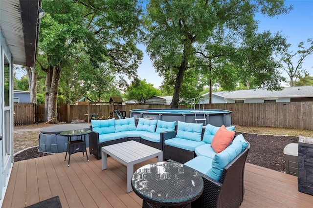 deck with a fenced backyard, an outdoor hangout area, and a fenced in pool