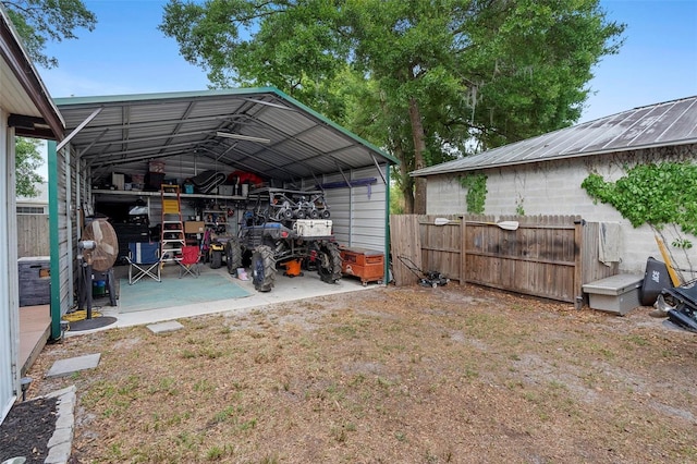 view of yard featuring a detached carport and fence