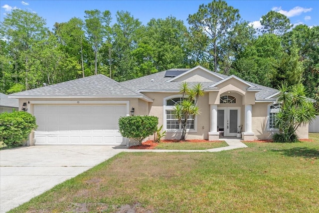 10 Zebrawood Ct, Palm Coast, FL 32164 - single story home with an attached garage, a front lawn, stucco siding, and french doors