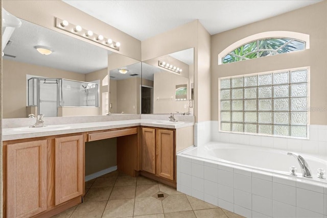 10 Zebrawood Ct, Palm Coast, FL 32164 - full bathroom with double vanity, a shower stall, a sink, and a garden tub