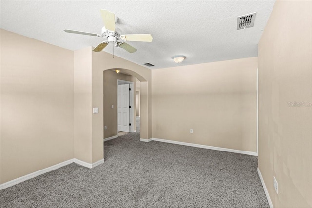 10 Zebrawood Ct, Palm Coast, FL 32164 - carpeted spare room with ceiling fan, arched walkways, a textured ceiling, baseboards, and visible vents