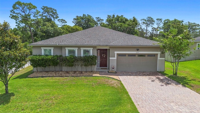2337 Oxmoor Dr, Deland, FL 32724 - single story home with stucco siding, an attached garage, a shingled roof, decorative driveway, and a front yard