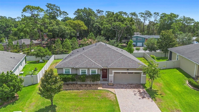 2337 Oxmoor Dr, Deland, FL 32724 - view of front of home featuring a garage, decorative driveway, roof with shingles, and stucco siding