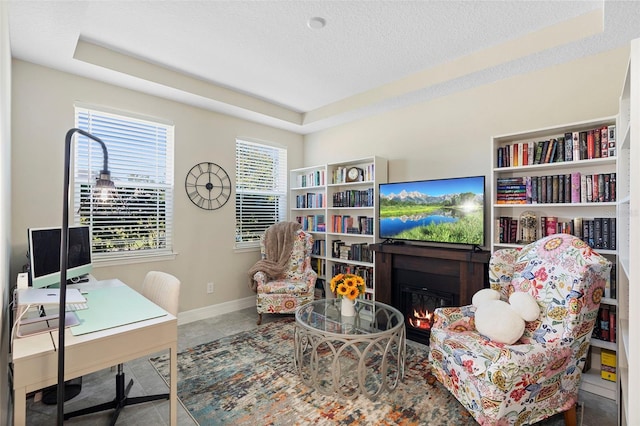2337 Oxmoor Dr, Deland, FL 32724 - tiled office featuring a glass covered fireplace, baseboards, and a textured ceiling