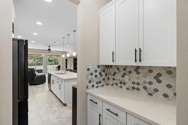 2337 Oxmoor Dr, Deland, FL 32724 - kitchen featuring a sink, light countertops, decorative backsplash, white cabinets, and recessed lighting