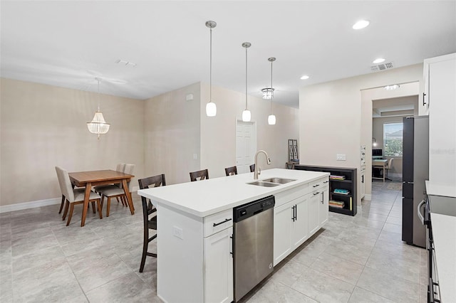 2337 Oxmoor Dr, Deland, FL 32724 - kitchen with appliances with stainless steel finishes, a sink, an island with sink, a breakfast bar, and white cabinetry