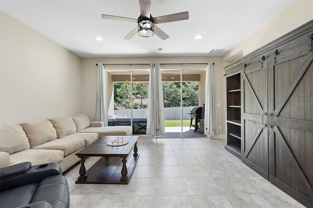 2337 Oxmoor Dr, Deland, FL 32724 - living room with recessed lighting, a ceiling fan, a barn door, and light tile patterned flooring