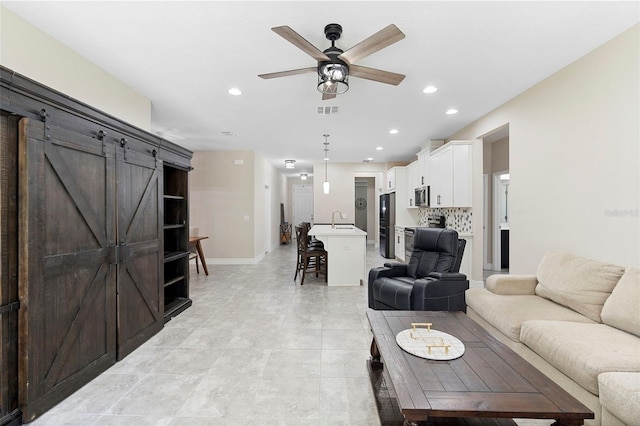 2337 Oxmoor Dr, Deland, FL 32724 - living area with ceiling fan, recessed lighting, baseboards, and a barn door