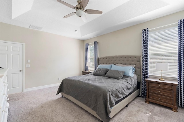 2337 Oxmoor Dr, Deland, FL 32724 - bedroom featuring light colored carpet, a tray ceiling, ceiling fan, and baseboards