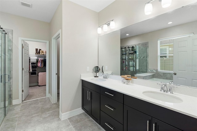 2337 Oxmoor Dr, Deland, FL 32724 - bathroom featuring a stall shower, double vanity, a garden tub, a spacious closet, and tile patterned floors
