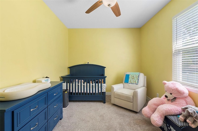 2337 Oxmoor Dr, Deland, FL 32724 - bedroom with light colored carpet, ceiling fan, a nursery area, and baseboards