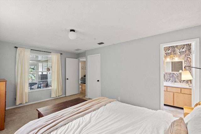 736 Lindenwood Cir W, Ormond Beach, FL 32174 - bedroom featuring connected bathroom and light carpet