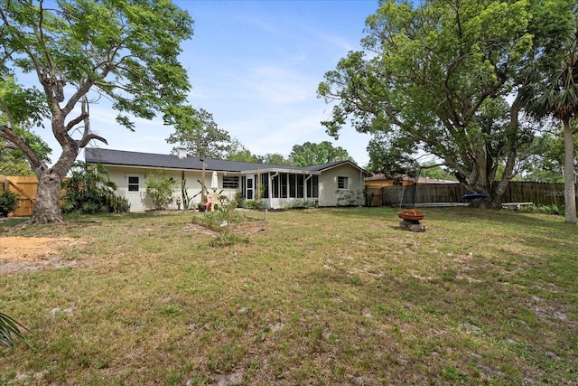 736 Lindenwood Cir W, Ormond Beach, FL 32174 - rear view of house featuring a fire pit and a sunroom