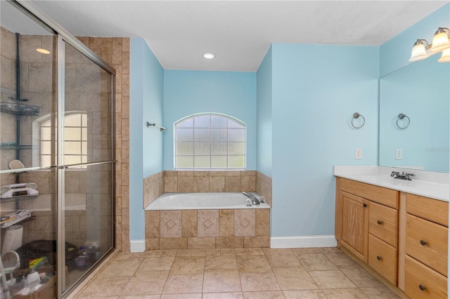 105 Riviera Estates Blvd, Ormond Beach, FL 32174 - full bathroom with baseboards, a garden tub, vanity, and a stall shower