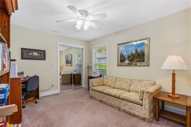 105 Riviera Estates Blvd, Ormond Beach, FL 32174 - carpeted living room featuring baseboards and ceiling fan