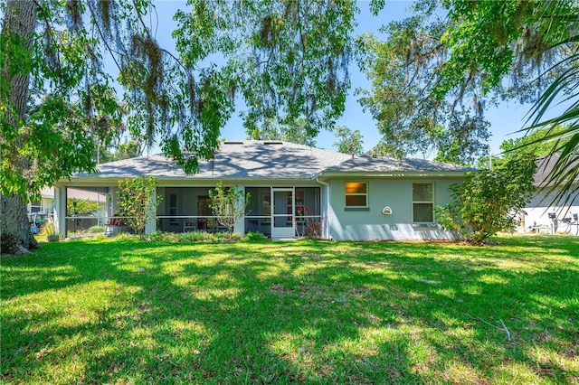 105 Riviera Estates Blvd, Ormond Beach, FL 32174 - back of house with a yard, a sunroom, and stucco siding