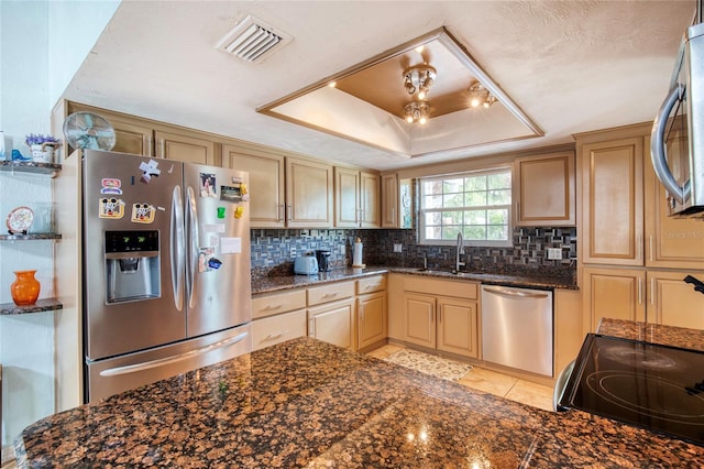 952 Northbrook Dr, Ormond Beach, FL 32174 - kitchen featuring backsplash, a raised ceiling, visible vents, a sink, and appliances with stainless steel finishes