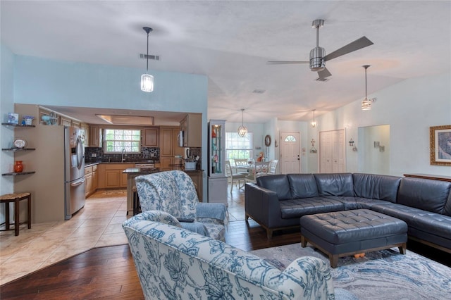952 Northbrook Dr, Ormond Beach, FL 32174 - living room with ceiling fan, vaulted ceiling, visible vents, and light wood-type flooring