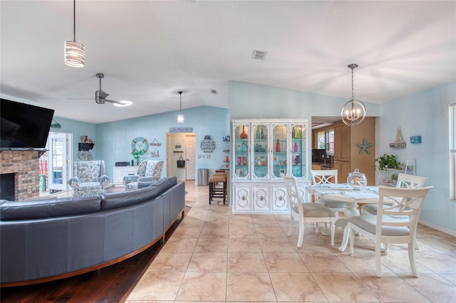 952 Northbrook Dr, Ormond Beach, FL 32174 - living area featuring lofted ceiling, a brick fireplace, visible vents, and ceiling fan with notable chandelier