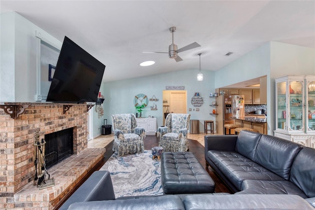 952 Northbrook Dr, Ormond Beach, FL 32174 - living room with wood finished floors, ceiling fan, a fireplace, lofted ceiling, and visible vents