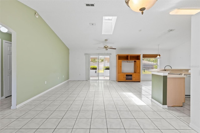 3214 Juniper Dr, Edgewater, FL 32141 - unfurnished living room featuring visible vents, light tile patterned flooring, a skylight, baseboards, and ceiling fan