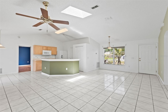 3214 Juniper Dr, Edgewater, FL 32141 - unfurnished living room featuring visible vents, a ceiling fan, light tile patterned floors, baseboards, and vaulted ceiling with skylight
