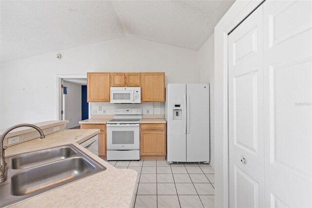 3214 Juniper Dr, Edgewater, FL 32141 - kitchen with a sink, light tile patterned flooring, vaulted ceiling, white appliances, and light countertops