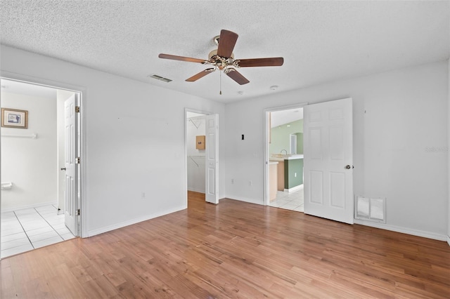 3214 Juniper Dr, Edgewater, FL 32141 - unfurnished bedroom with a spacious closet, wood finished floors, visible vents, and connected bathroom