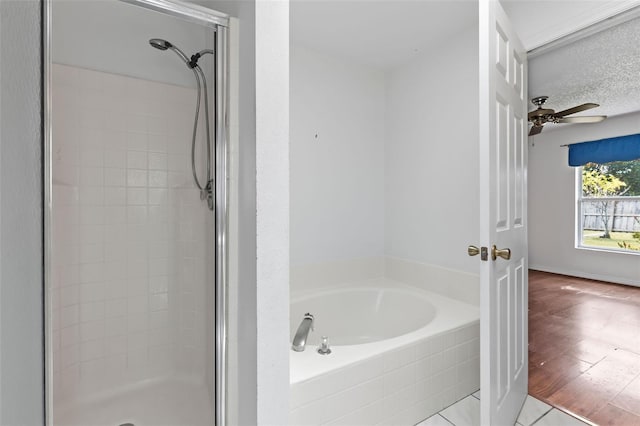 3214 Juniper Dr, Edgewater, FL 32141 - full bath featuring a shower stall, a ceiling fan, a bath, and tile patterned flooring