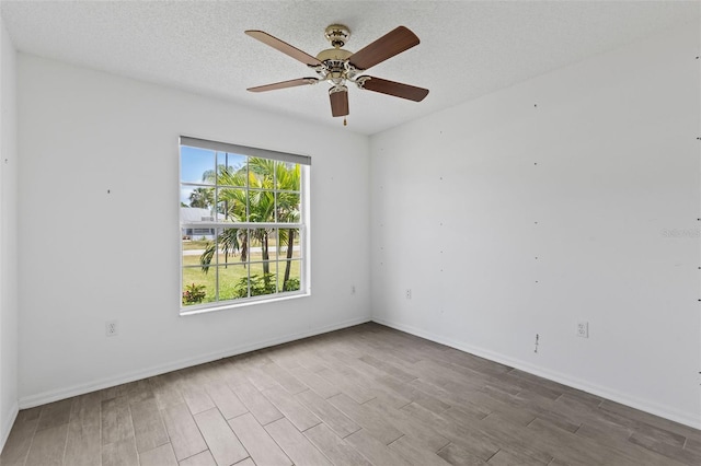 3214 Juniper Dr, Edgewater, FL 32141 - unfurnished room featuring wood finished floors, a textured ceiling, baseboards, and ceiling fan