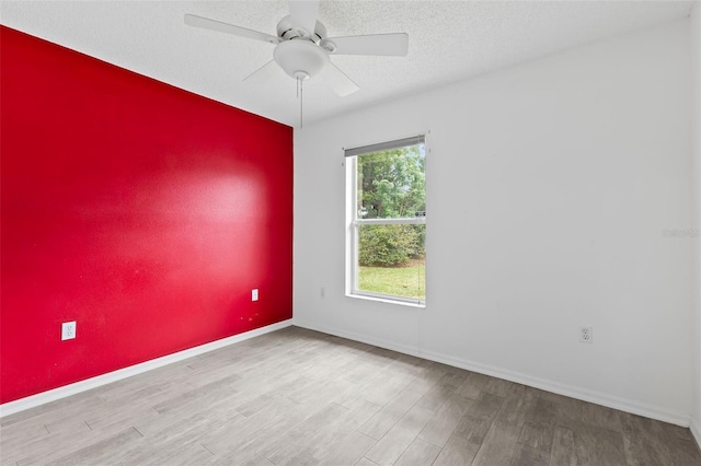 3214 Juniper Dr, Edgewater, FL 32141 - spare room featuring baseboards, a ceiling fan, wood finished floors, and a textured ceiling