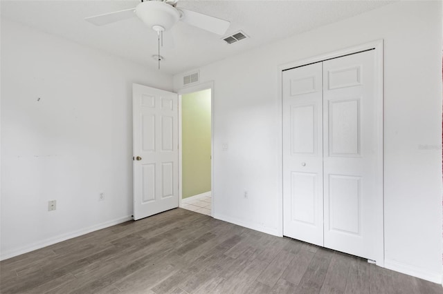 3214 Juniper Dr, Edgewater, FL 32141 - unfurnished bedroom featuring baseboards, wood finished floors, visible vents, and a closet